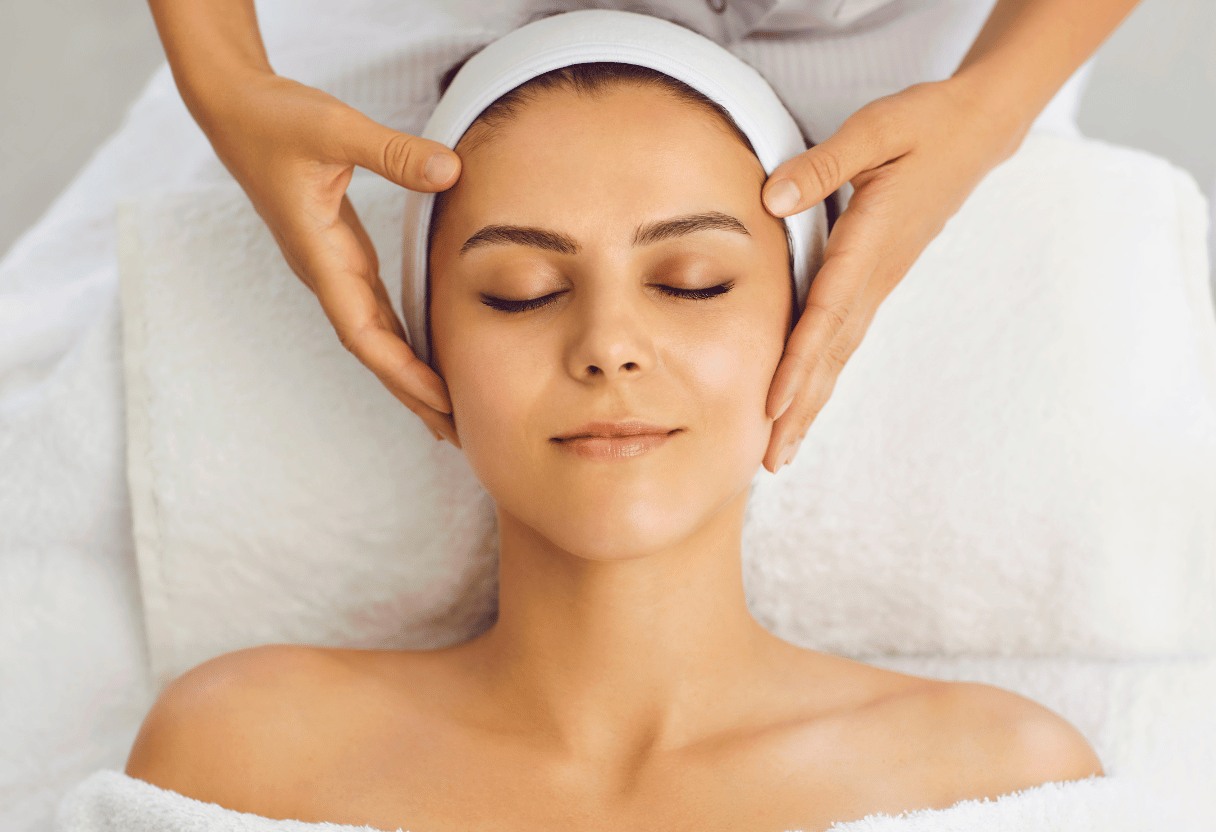 A woman enjoying a facial massage, highlighting relaxation and stress relief benefits.
